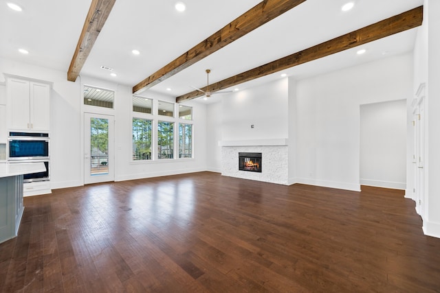 unfurnished living room with dark hardwood / wood-style floors and beamed ceiling