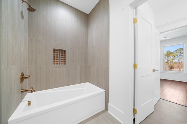 bathroom featuring tiled shower / bath and tile patterned flooring