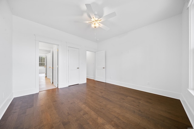 unfurnished bedroom featuring ceiling fan and dark wood-type flooring