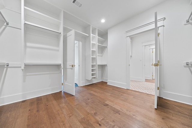 walk in closet with hardwood / wood-style floors