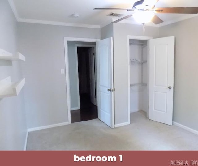 unfurnished bedroom featuring a closet, light colored carpet, crown molding, and ceiling fan