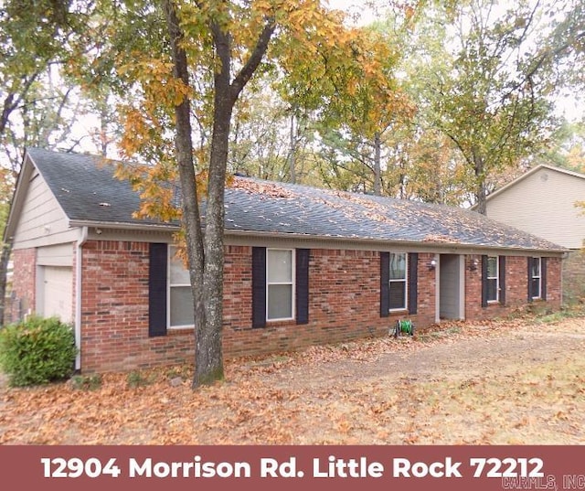 ranch-style home featuring a garage