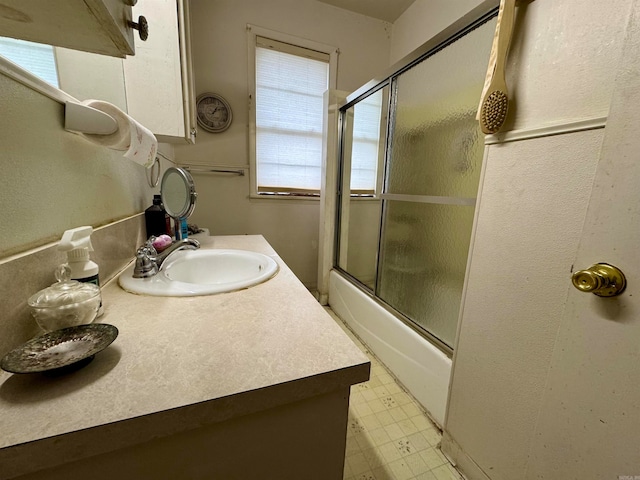 bathroom featuring vanity and enclosed tub / shower combo