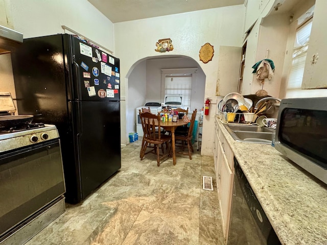 kitchen featuring range hood, stainless steel appliances, and sink