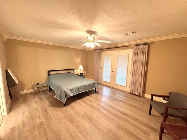 bedroom featuring french doors, ornamental molding, light hardwood / wood-style floors, and access to outside