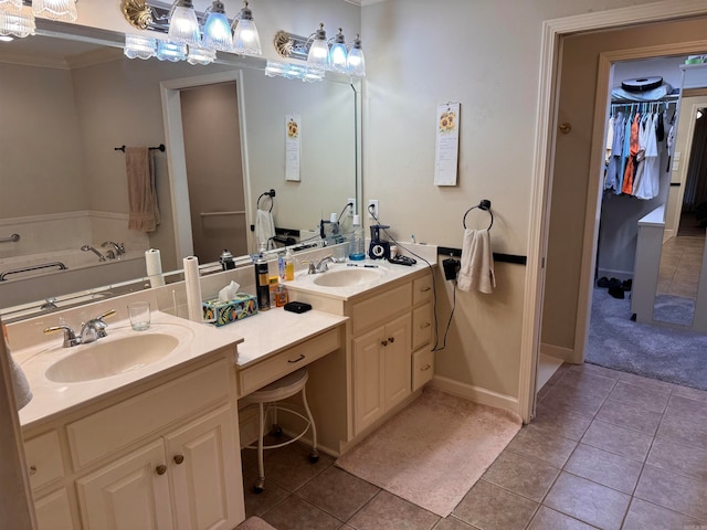 bathroom with crown molding, tile patterned floors, and vanity