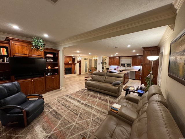 living room with hardwood / wood-style floors, ornamental molding, and a textured ceiling