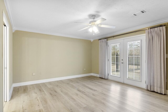 spare room featuring light wood-type flooring, ornamental molding, ceiling fan, a textured ceiling, and french doors