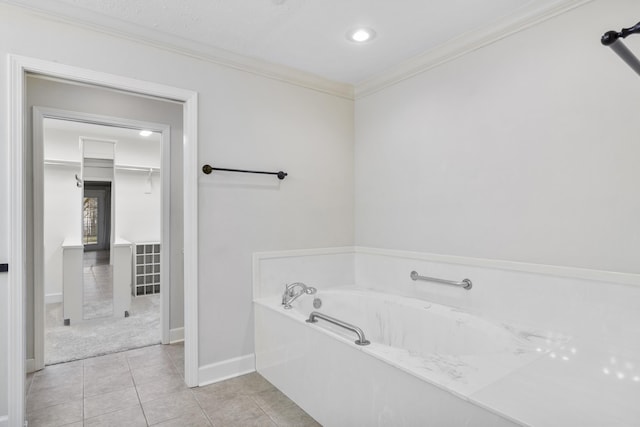 bathroom featuring a bathtub, crown molding, and tile patterned floors