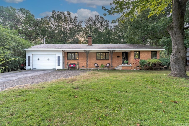 ranch-style house featuring a garage, a front lawn, and a porch