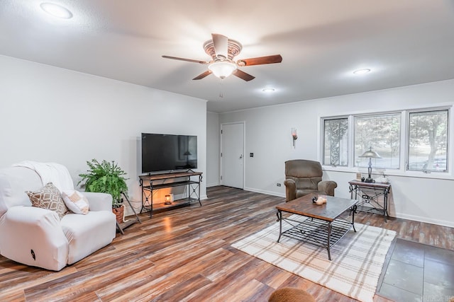 living room featuring hardwood / wood-style floors and ceiling fan