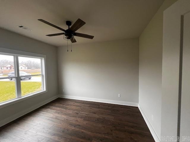 unfurnished room with dark hardwood / wood-style floors and ceiling fan