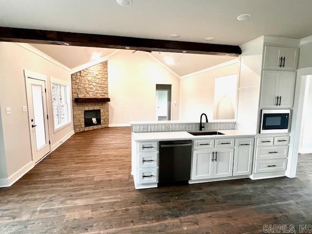 kitchen with vaulted ceiling with beams, white cabinetry, black dishwasher, and sink