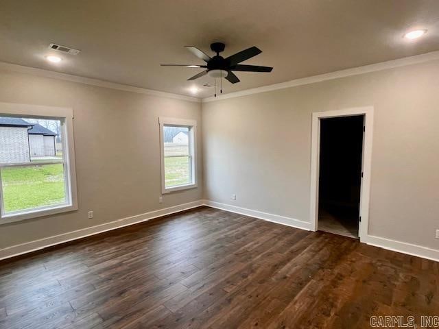 empty room with dark hardwood / wood-style flooring, crown molding, and ceiling fan