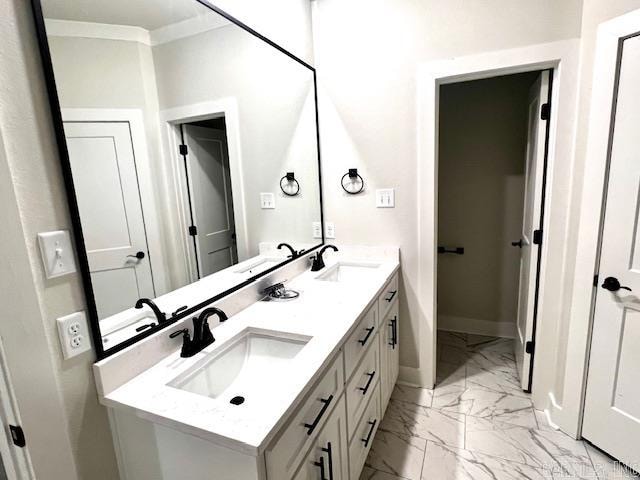 bathroom with vanity and ornamental molding