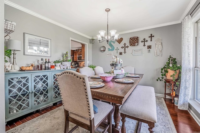 dining area with crown molding, dark hardwood / wood-style floors, and a chandelier