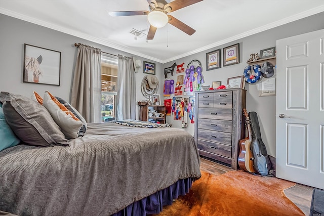 bedroom with ornamental molding, hardwood / wood-style floors, and ceiling fan