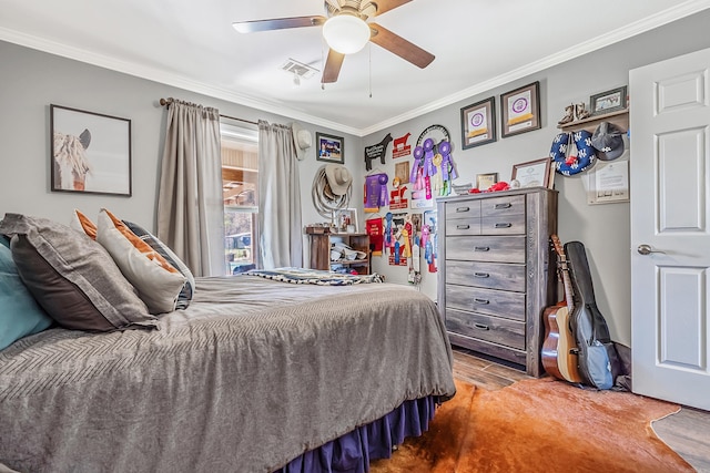 bedroom with ornamental molding, wood-type flooring, and ceiling fan