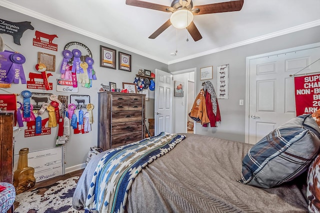 bedroom with crown molding, wood-type flooring, and ceiling fan