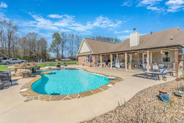 view of swimming pool with a patio area