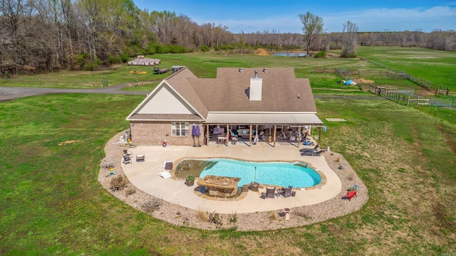 view of pool with a yard and a patio area