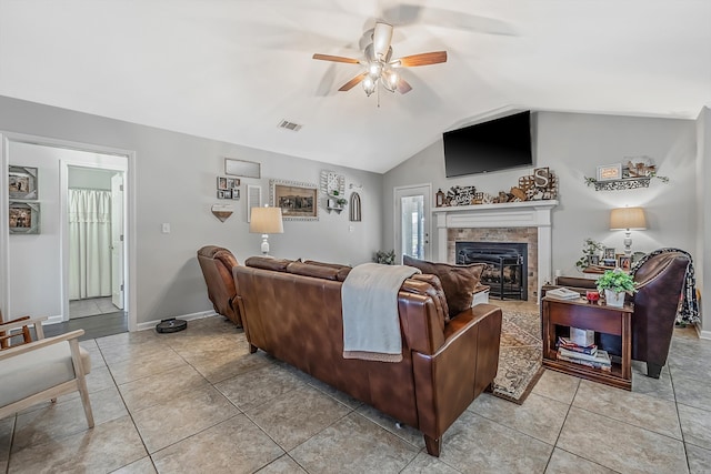 tiled living room featuring ceiling fan and vaulted ceiling