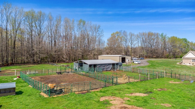 view of yard with an outbuilding and a rural view