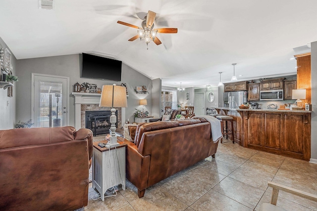 living room featuring light tile patterned flooring, vaulted ceiling, and ceiling fan