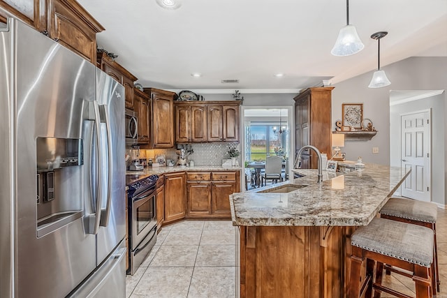 kitchen with decorative backsplash, ornamental molding, sink, pendant lighting, and appliances with stainless steel finishes