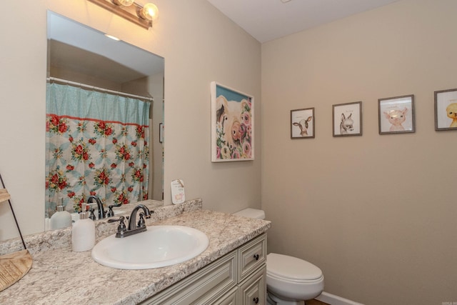 bathroom featuring vanity and toilet