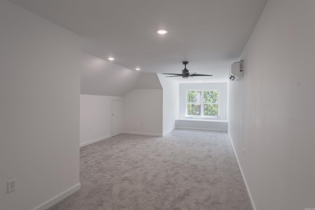 additional living space with light carpet, lofted ceiling, a wall mounted AC, and ceiling fan