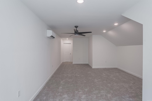 bonus room featuring lofted ceiling, a wall mounted air conditioner, light colored carpet, and ceiling fan