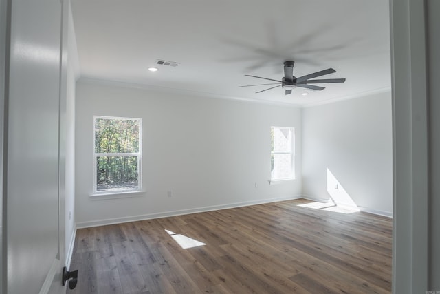 unfurnished room featuring a wealth of natural light, crown molding, and hardwood / wood-style flooring