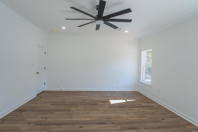 spare room with crown molding, ceiling fan, and dark hardwood / wood-style flooring