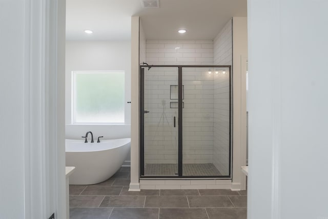 bathroom featuring separate shower and tub and tile patterned flooring