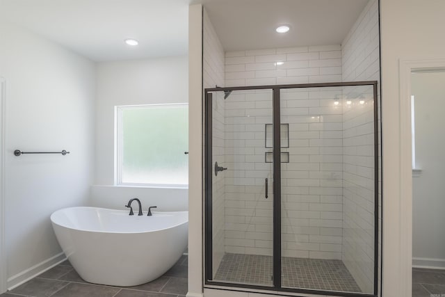 bathroom with tile patterned flooring and shower with separate bathtub