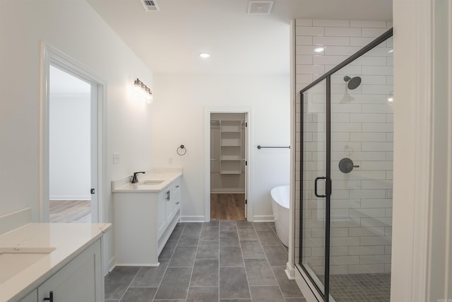 bathroom featuring vanity, independent shower and bath, and tile patterned flooring