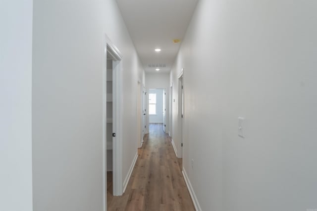 hallway featuring hardwood / wood-style flooring