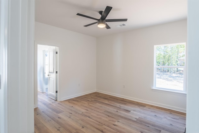 spare room featuring ceiling fan and light hardwood / wood-style flooring