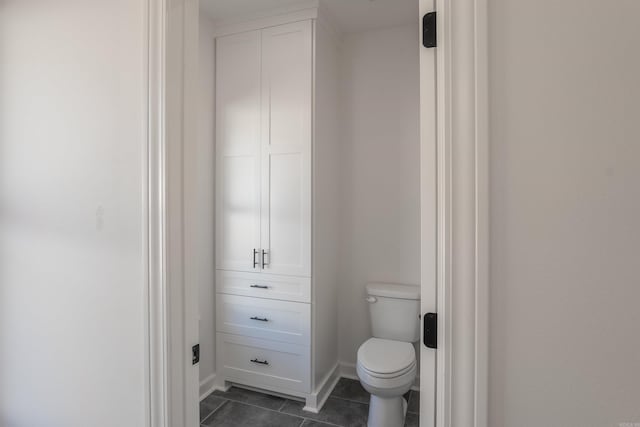 bathroom with toilet and tile patterned flooring