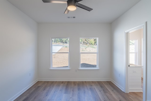 empty room featuring light wood-type flooring and ceiling fan