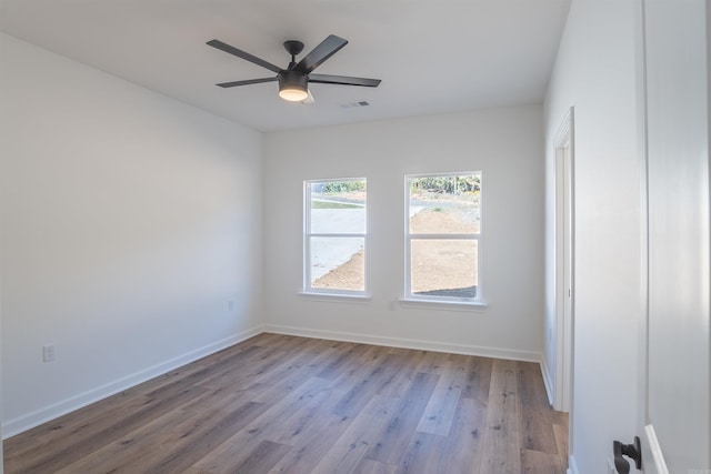 spare room with ceiling fan and light wood-type flooring