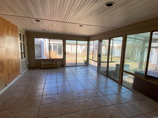 unfurnished sunroom featuring wood ceiling and an AC wall unit