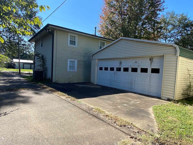 view of side of property with an outdoor structure and a garage