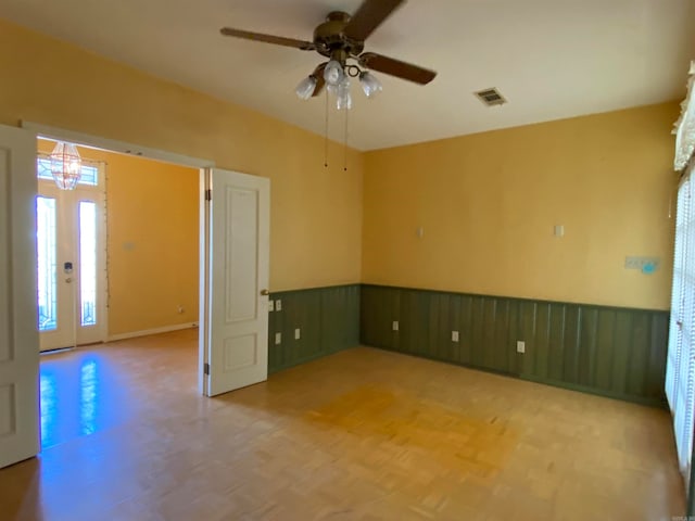 unfurnished room featuring parquet floors and ceiling fan