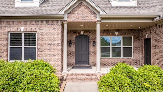 view of exterior entry featuring a porch