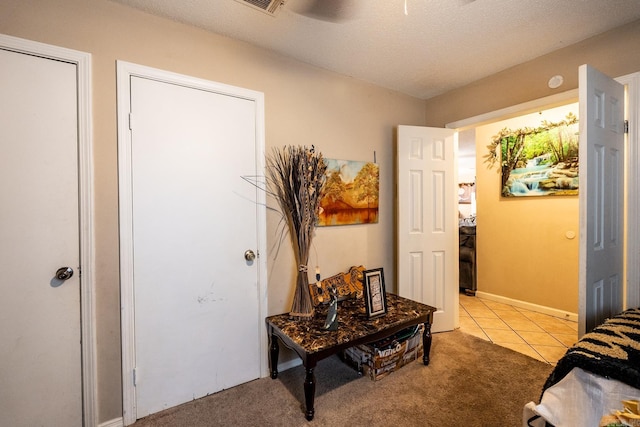 interior space with light carpet and a textured ceiling