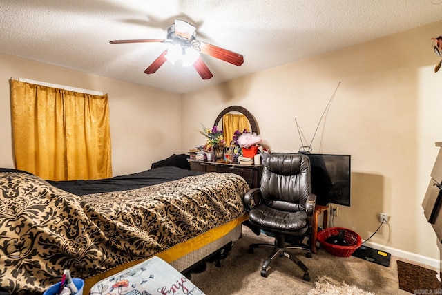 carpeted bedroom featuring a textured ceiling and ceiling fan