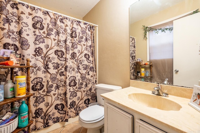 bathroom with a textured ceiling, toilet, vanity, a shower with shower curtain, and tile patterned flooring