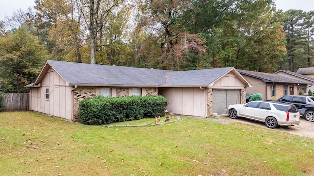 ranch-style home featuring a garage and a front lawn